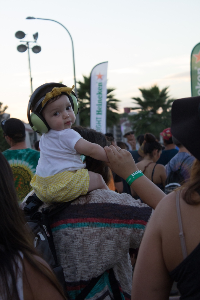 A mother watches Seedless play on Sunday afternoon, her daughter with the best seat in the house. 